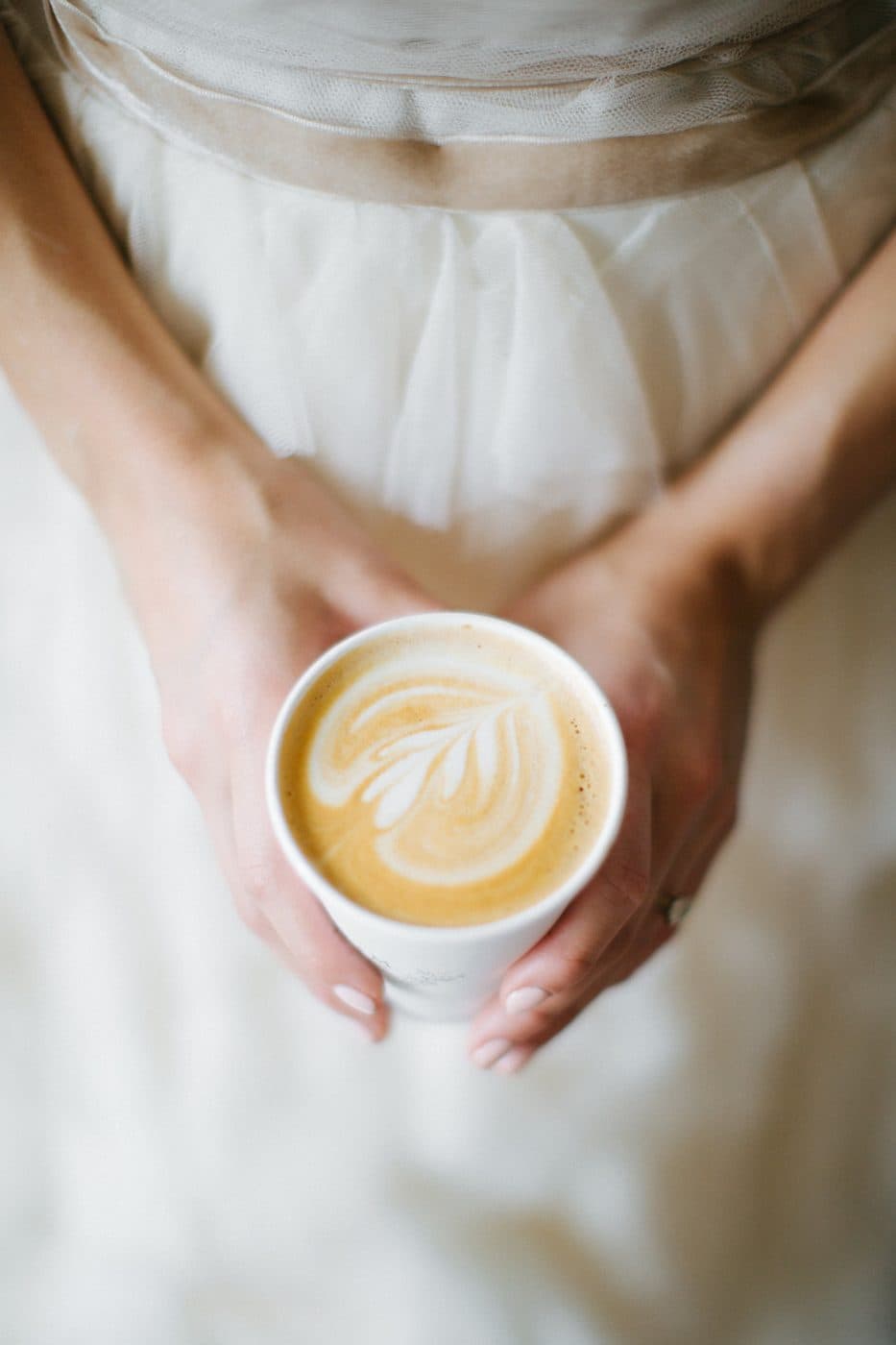 Bride holding a latte from the wedding coffee cart
