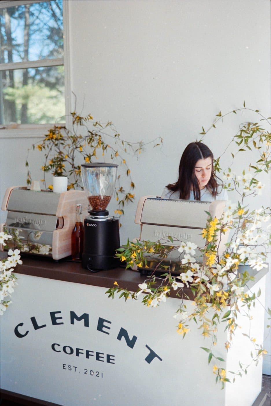 Clement Coffee mobile coffee cart dressed with florals, barista pulling espresso at an Atlanta-area event