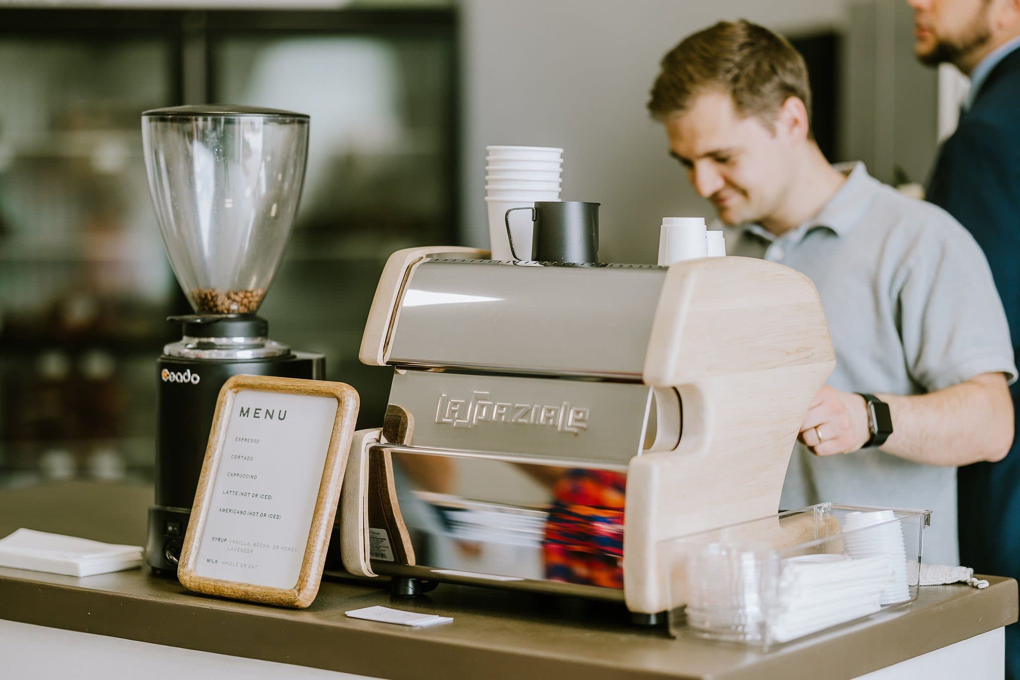 Espresso machine and grinder on the Clement Coffee mobile espresso bar with a guest ordering